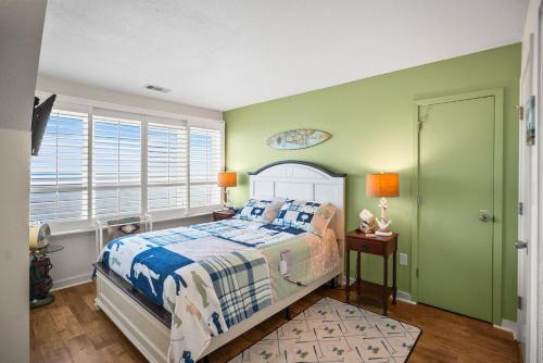 a bedroom with a bed and green walls at 630 New Haven - Dolphin Pointe in Fripp Island