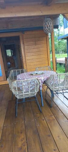 a table and chairs on a wooden deck at Kucica Janja in Ulcinj