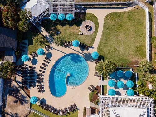 an overhead view of a swimming pool with blue umbrellas at 133 Captain John Fripp - 3 BD/2 BA with Resort Amenities! in Fripp Island