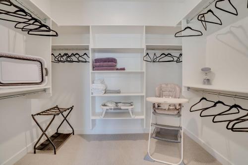 a dressing room with white walls and white shelves at Heber Retreat by Xquisite Rentals in Heber City