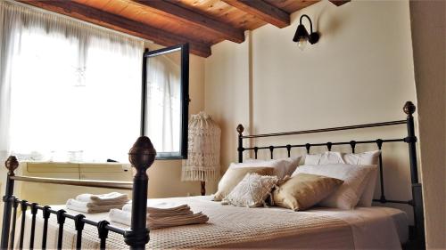 a bedroom with a bed with a large window at Dionysus Blue Sky in Egina