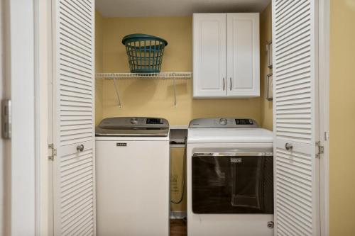a small kitchen with white cabinets and a stove at 115 Capt John Fripp Villa in Fripp Island