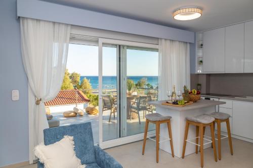 a kitchen and living room with a view of the ocean at Irida Luxury house in Kámpos