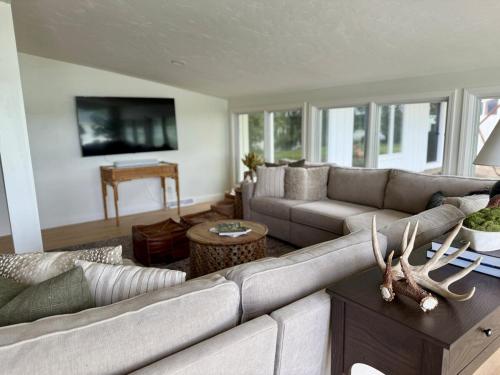 a living room with a couch and a table at Remodeled Lake Retreat Putting Green, Game RoomBar in Green Lake