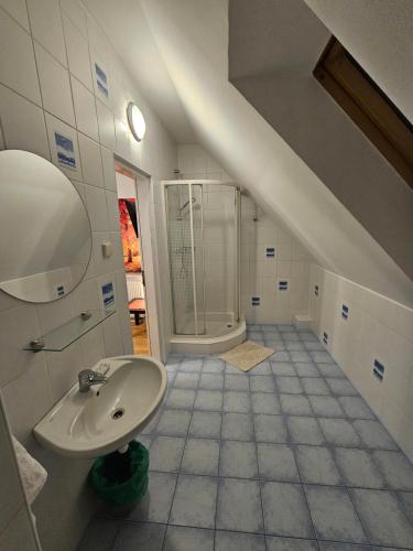 a bathroom with a sink and a shower at Noclegi Węgierska Górka in Węgierska Górka
