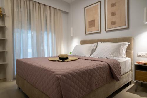 a bedroom with a bed with a hat on it at Irida Luxury house in Kámpos