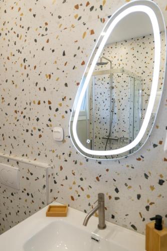 a bathroom with a mirror over a sink at Irida Luxury house in Kámpos