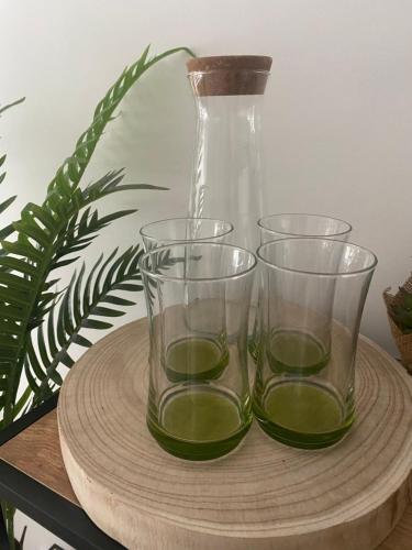 three glasses on a wooden tray with a vase at Buda Side Comfort in Budapest