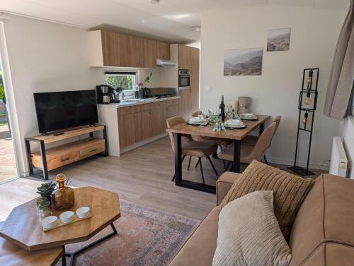 a living room with a couch and a table at Holiday House 4 guests at Spaarnwoude in Velsen-Zuid