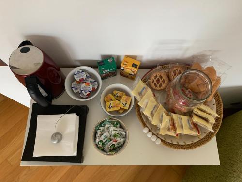 a table topped with plates of food and snacks at B&B da Viky in Marostica