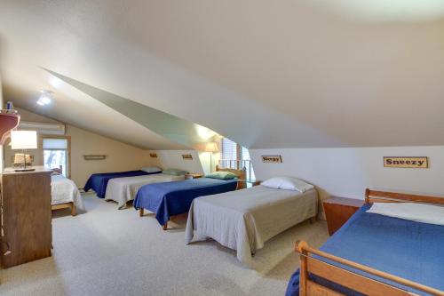 a bedroom with three beds in a attic at Large Home on Lake Edward with Deck and Fire Pit! in Nisswa