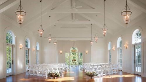a large room with white tables and chairs in it at Signature 5 Bedroom Lagoon Residence 1003 in Bluffton