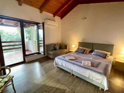 a bedroom with a large bed and a couch at Ribarica GO green in Ribarica