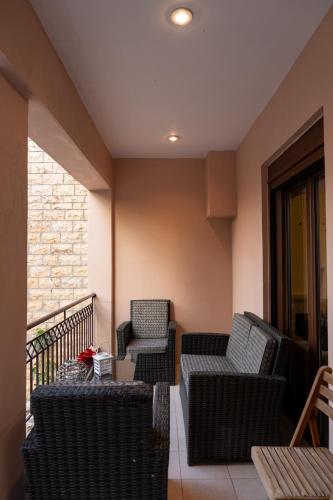 a patio with two chairs and a table on a balcony at The Sheriff's Beach House in Lóngos