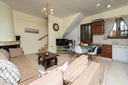 a living room with a couch and a table at The Sheriff's Beach House in Lóngos