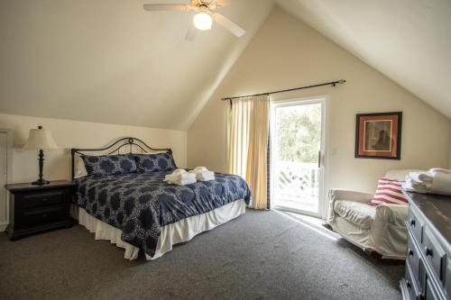 a bedroom with a bed and a large window at 48 Davis Love in Fripp Island