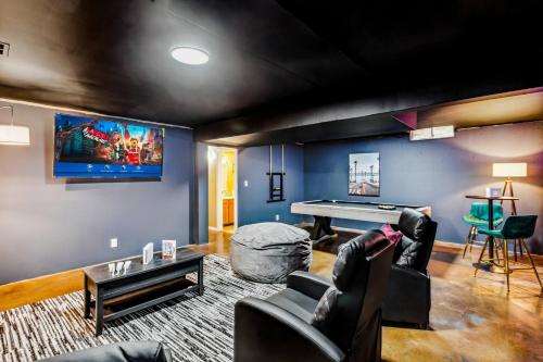 a living room with a couch and a ping pong table at Theater, King&PoolTable with PrivateHotTub in The Dell