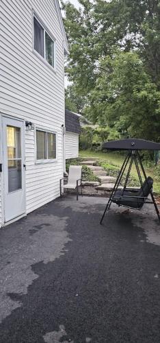 a barbecue grill in the driveway of a house at Tilto Executive suite in Saint John