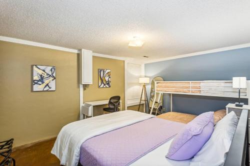 a bedroom with a bed with purple pillows at Theater, King&PoolTable with PrivateHotTub in The Dell