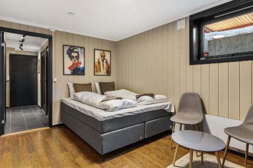 a bedroom with a bed and chairs in it at Trysilfjell 33 by Vacation Trysil in Trysil