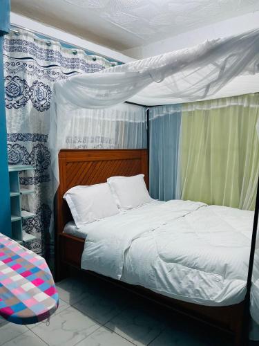 a bedroom with a bed with a canopy at Jordan House in Voi