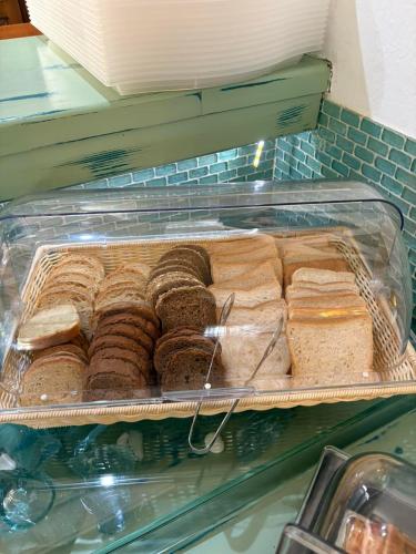 a display case filled with lots of different types of donuts at Hotel Pegasus-Adult Friendly in Limenas