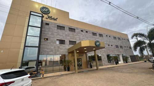 a building with a car parked in front of it at Felipe Hotel in Serra Talhada