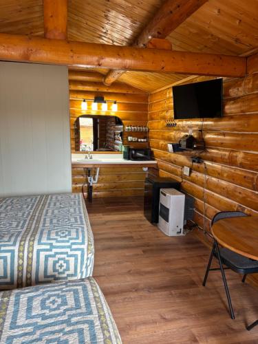 a bedroom with two beds and a desk in a cabin at Burnt Paw in Tok