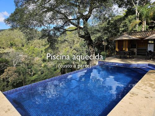 an image of a swimming pool in front of a house at Vaca do Brejo, piscina aquecida, sauna, A/C quente in Petrópolis