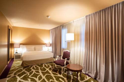 a hotel room with a bed and a window at Holiday Inn Porto Gaia by IHG in Vila Nova de Gaia