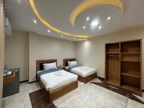 a bedroom with two beds and a circular ceiling at The Pyramids Crypt Inn in Cairo