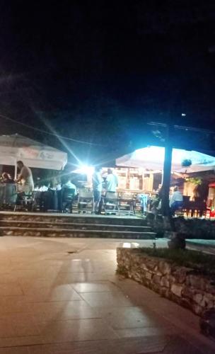 a group of people standing under a tent at night at Парк - Хотел Макензен in Melnik