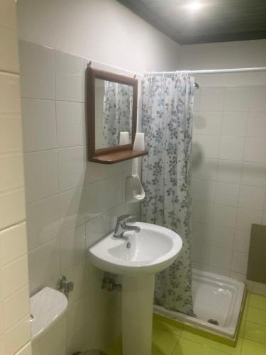 a bathroom with a sink and a mirror and a shower at Liberty-Room N2 in Georgioupolis