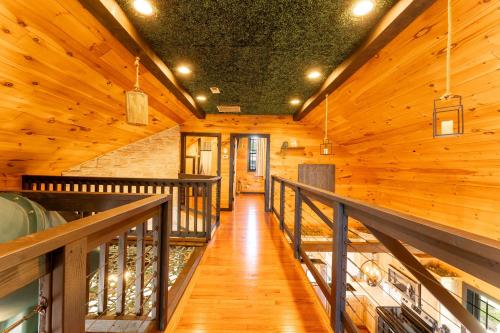 a hallway in a log cabin with a wooden ceiling at Sunset Ridge cabin 21 miles from Chatt TN Indoor pool & hot tub in Bryant