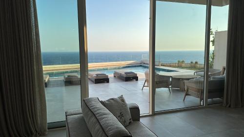 a living room with a view of the ocean at Vila Palasea in Palasë
