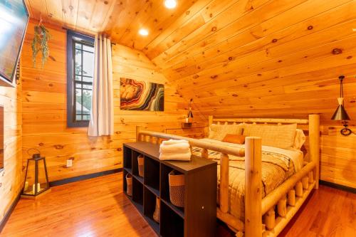 a bedroom with a bed in a log cabin at Sunset Ridge cabin 21 miles from Chatt TN Indoor pool & hot tub in Bryant