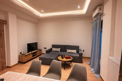 a living room with a couch and a tv at Casa Vacanza in Zakharo