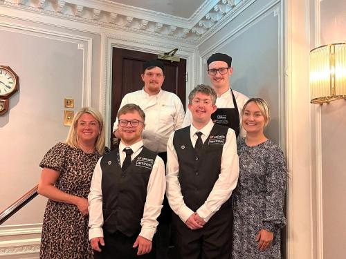 a group of people posing for a picture at Foxes Hotel in Minehead