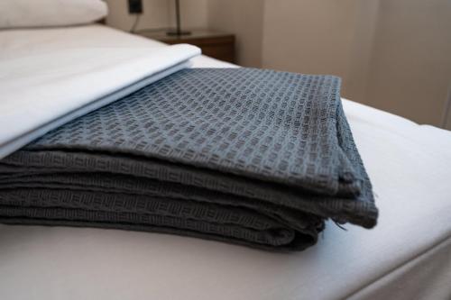 a stack of pillows sitting on top of a bed at Casa Vacanza in Zakharo