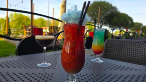 two cocktails sitting on top of a table at Warsoliv double in Warsaw