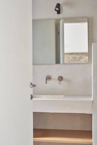 a bathroom with a sink and a mirror at Trullo Antonelli in Antonelli
