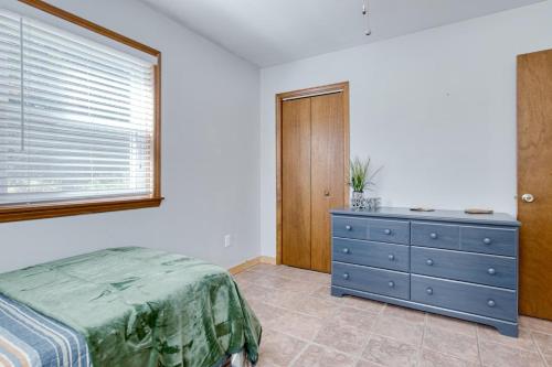 a bedroom with a blue dresser and a window at New River 3BR - Fishing, Hot Tub and VT Game Weekends in Radford
