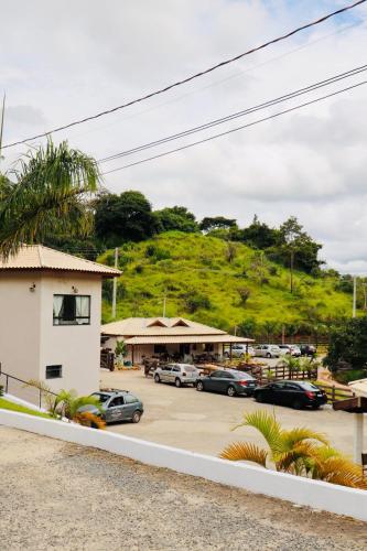 a parking lot with cars parked in front of a building at Hotel Pousada Riacho da Areia in Águas de Lindóia