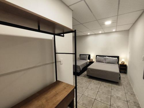a bedroom with two beds in a room at Villa Bilac - Amplos Studios 2km da Vila Germânica in Blumenau