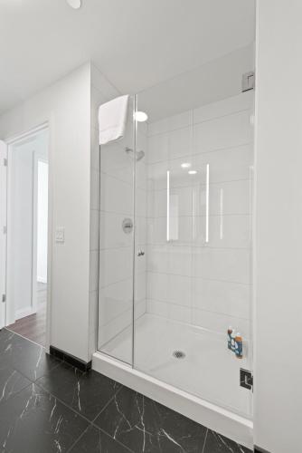 a shower with a glass door in a bathroom at Lux Apts with Lake Views and Top Amenities in Chicago