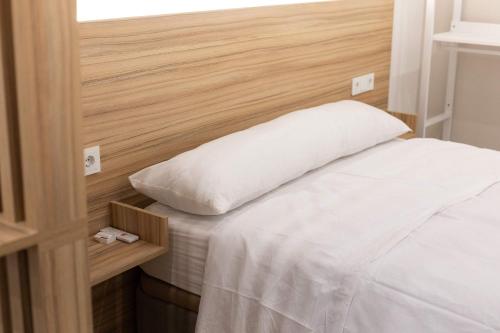 a bed with a white pillow on top of it at Luxury Apartment Oceanografic 9 in Valencia