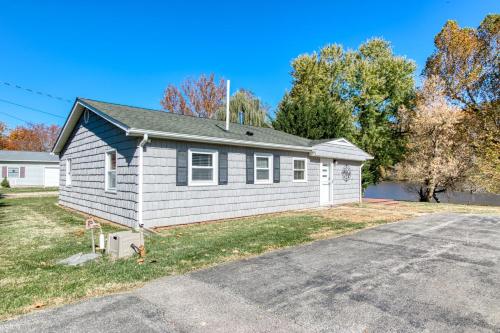 a house on a street with a driveway at New River 3BR - Fishing, Hot Tub and VT Game Weekends in Radford