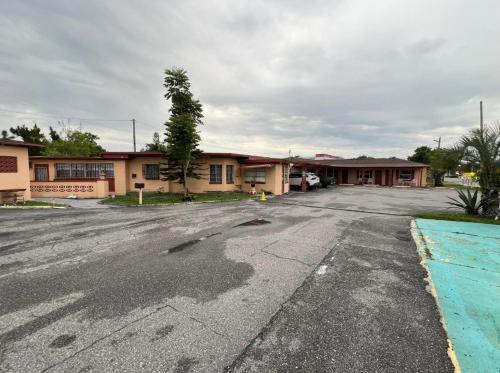 an empty parking lot in front of a motel at Slumberland Motel in Sanford