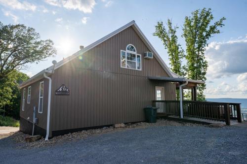 a brown building with a window on the side at Mountain High Cabin with hot tub fire pit & indoor pool in Bryant