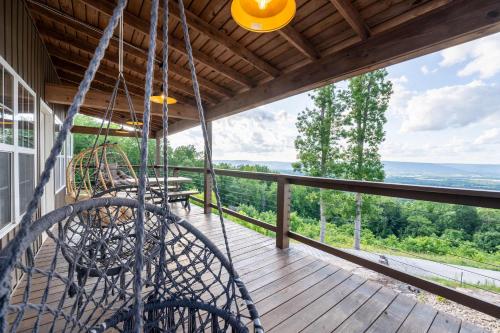 a balcony with a view of the mountains at Mountain High Cabin with hot tub fire pit & indoor pool in Bryant